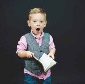 Boy Shocked holding a book