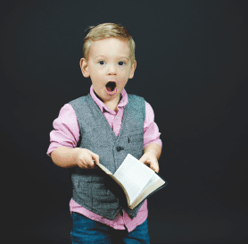 Boy Shocked holding a book